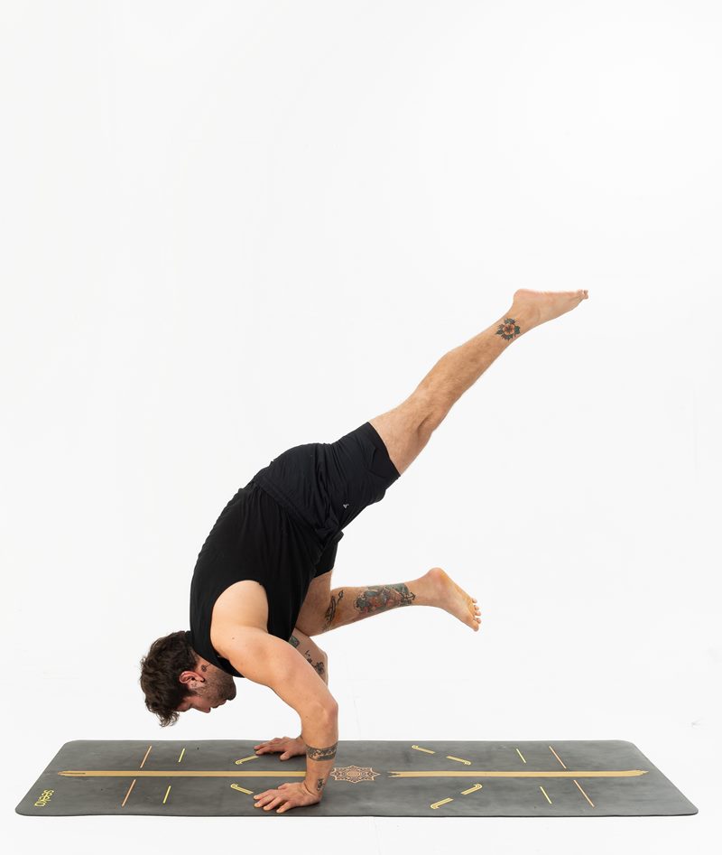 İzmir stüdyoda erkek yoga eğitmeninin uçan kol dengesinde havada süzüldüğü dinamik Kentli Gurular yoga fotoğraf çekimi.